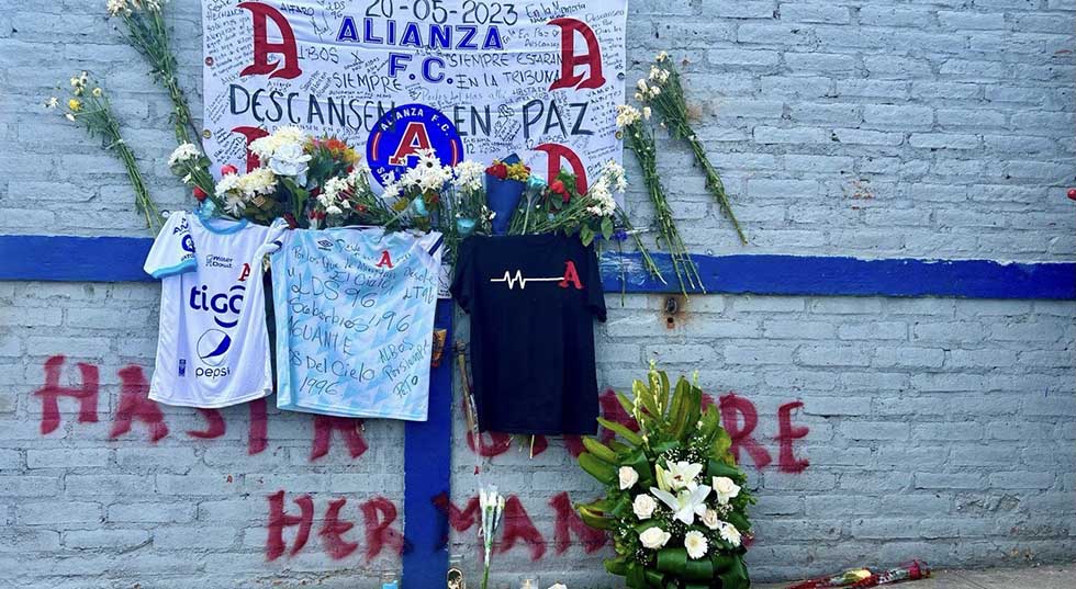Aficionados llevan flores al altar de las víctimas de la estampida en el Estadio Cuscatlán  